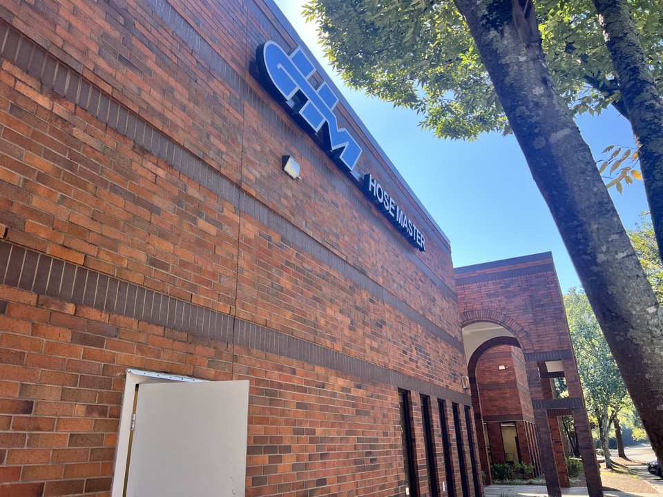 Hose Master facility exterior with HM building signage