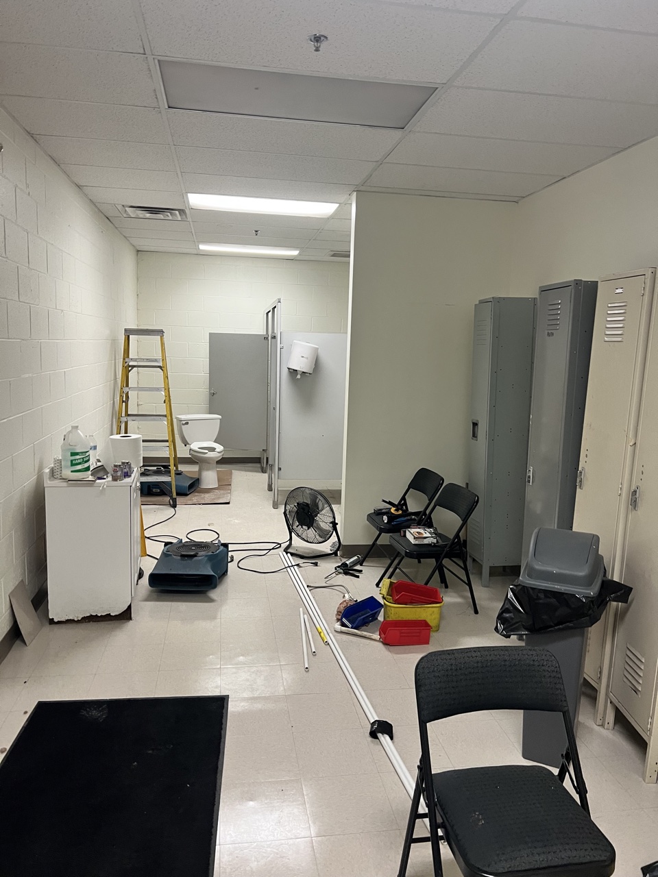 Restroom and locker area during drywall repair work