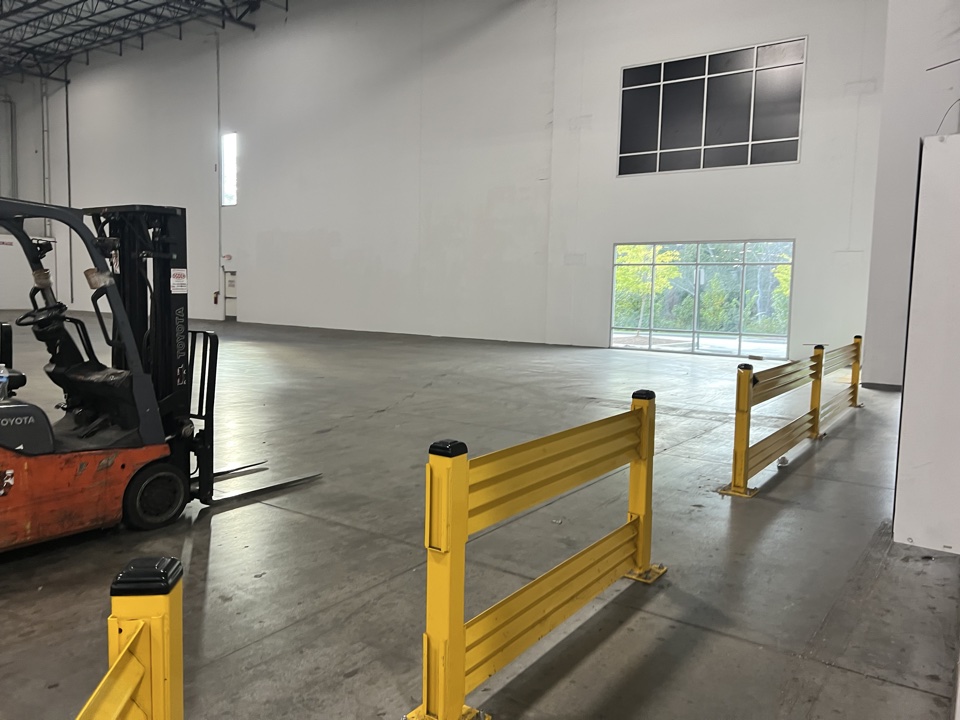 Warehouse floor with forklift and safety rails
