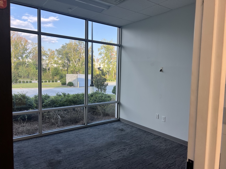 Corner office with large windows and freshly painted walls
