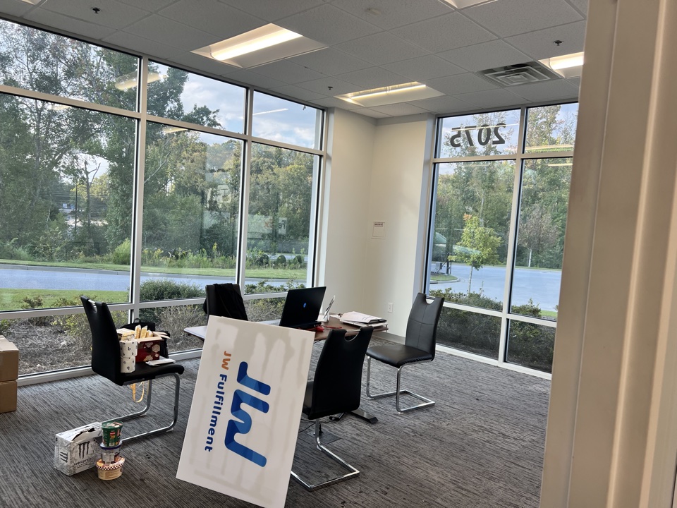 Meeting room with JW Fulfillment signage and painted walls