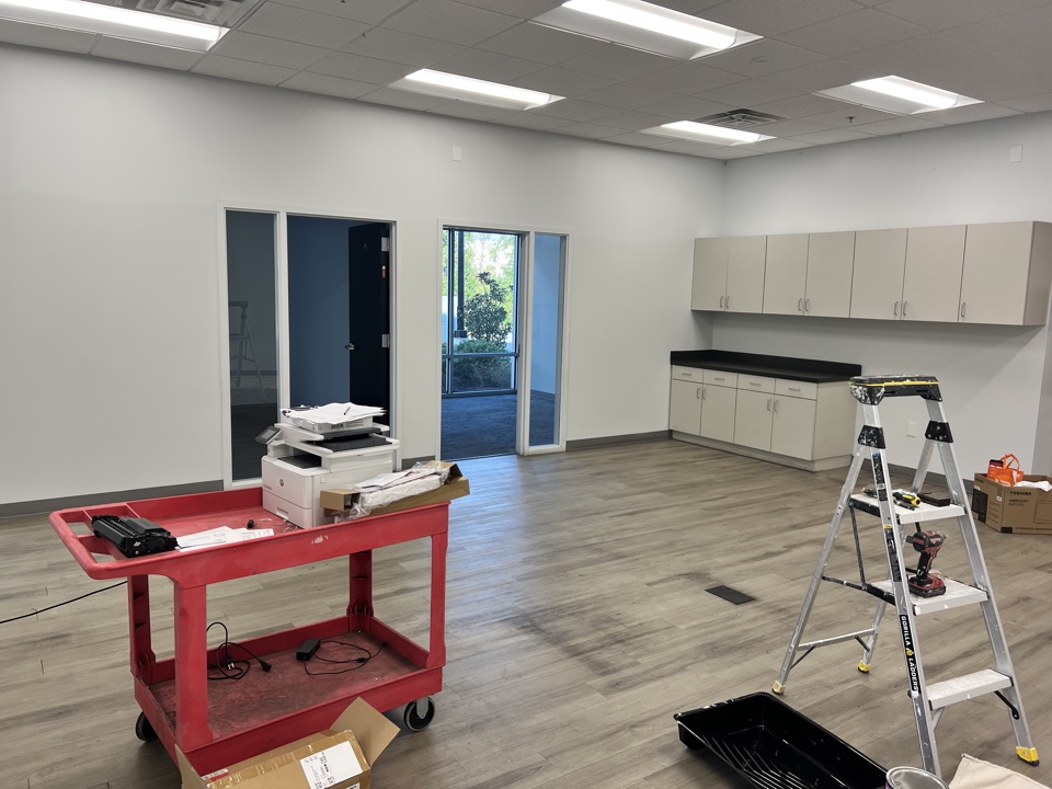 Open office area during final wall repair and painting work